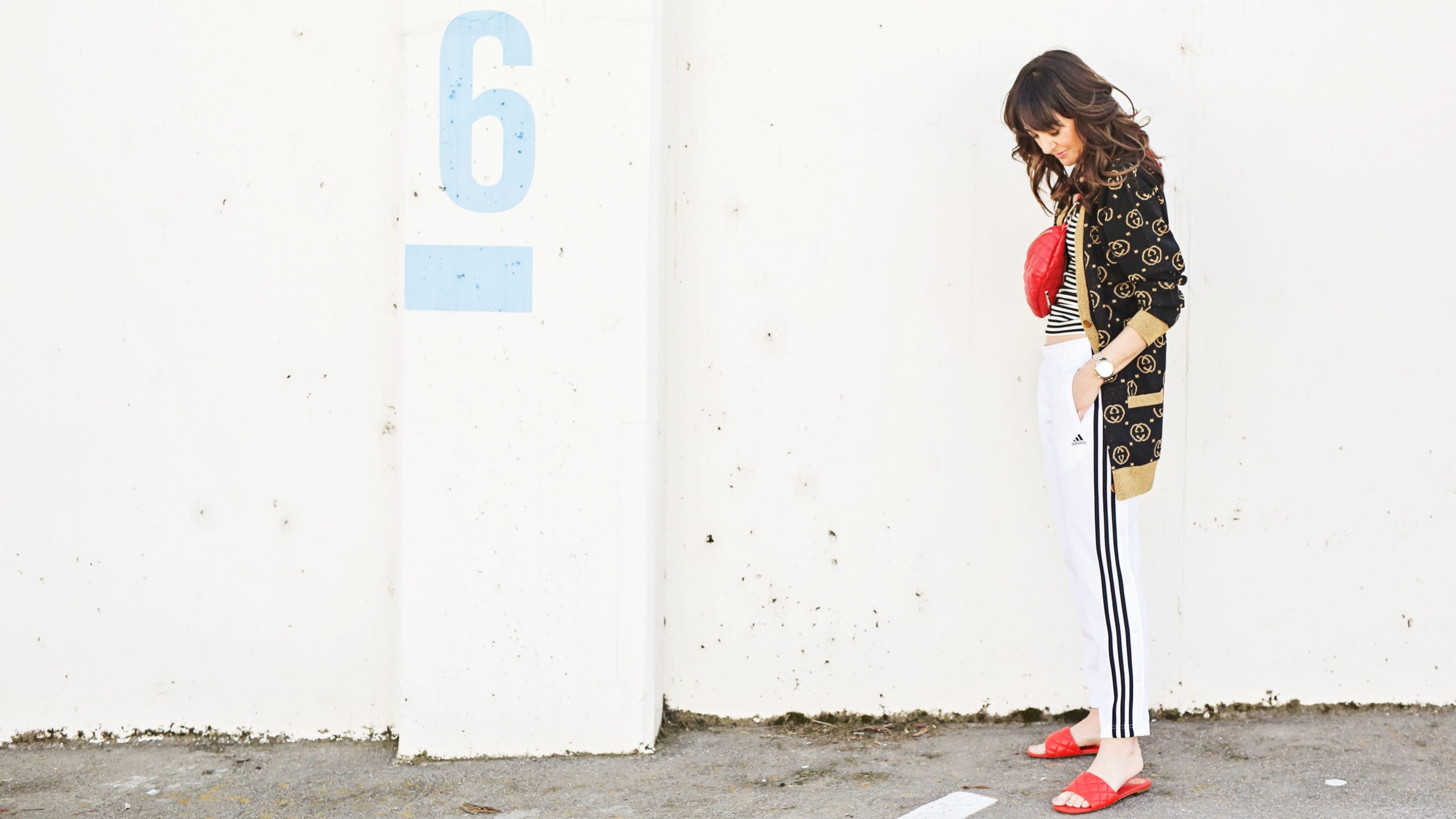Jennifer Sattler Stylist street style track pant outfit Sacramento Ca red flat quilted sandals black and whtie addias track pants black and gold gucci cardigan black and white tank top red belt bag red cross body bag