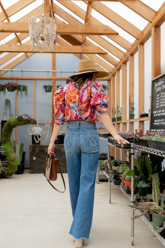 Jennifer Sattler Stylist at the Prickly Pear in Sacramento CA wearing Mother tomcat roller wide leg flare jeans sun hat farm rio pink top gucci blet and gucci purse shopping for succulents Marc fisher plastform sandals summer trends 2022