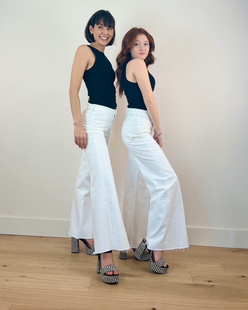 petite red head model and regular brunette model showing white MOTHER Roller Jeans 