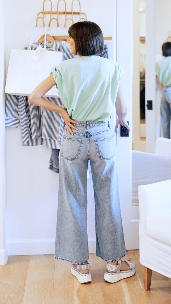  Jen in her closet having coffee wearing Fidelity Wide Leg Tencel Jeans | MOTHER GRAPHIC TEE | Designer Inspired Sandals