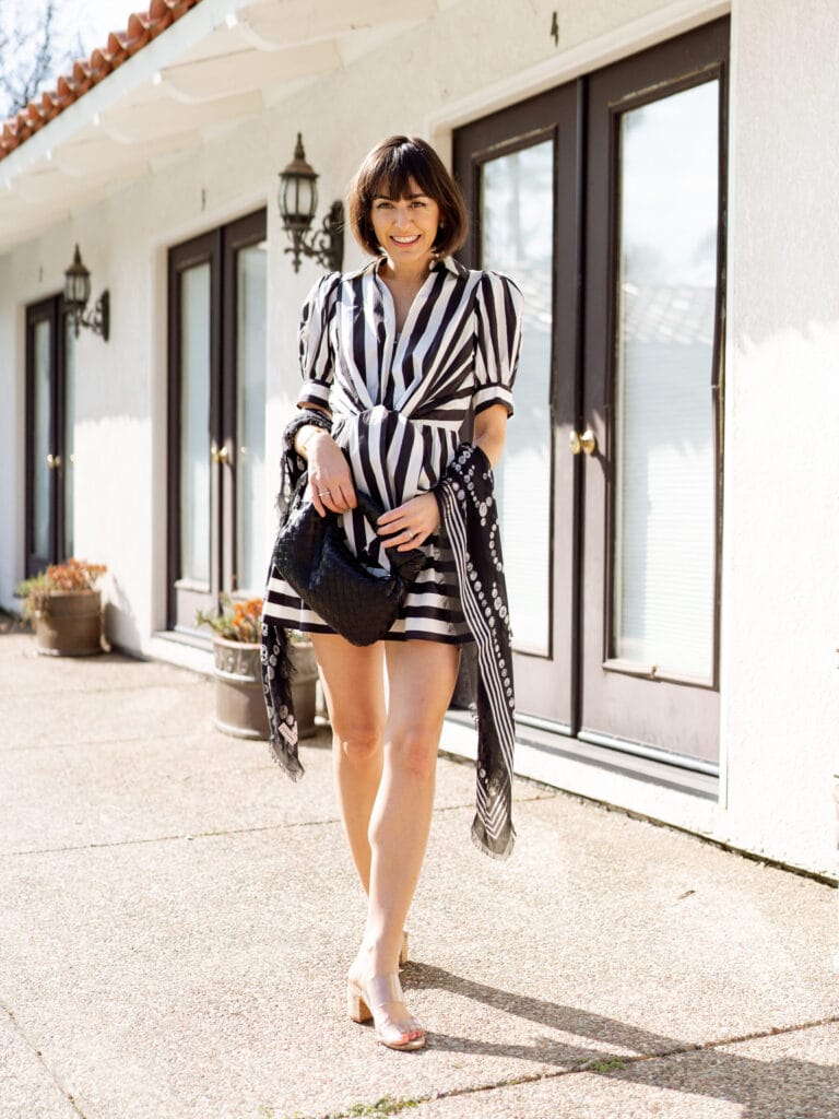 Woman on vacation wearing a short black and white dress